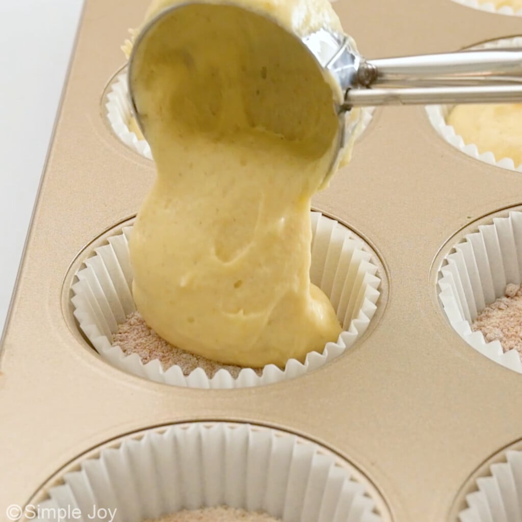 adding more batter to coffee cake muffins