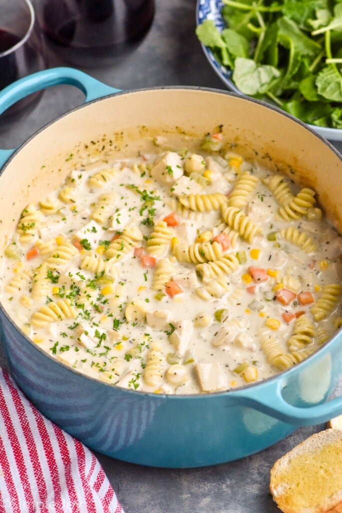 Pot of Turkey Soup with bowl of salad beside