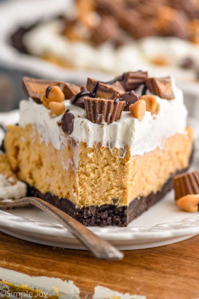 Close up photo of a slice of Peanut Butter Pie with a bite taken out. Fork beside.