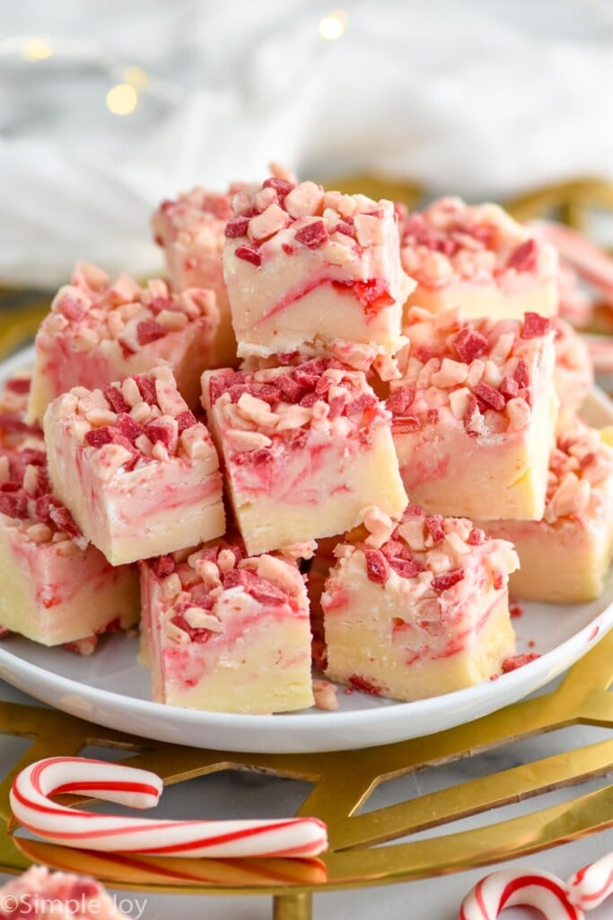 peppermint fudge on a plate with candy canes in front