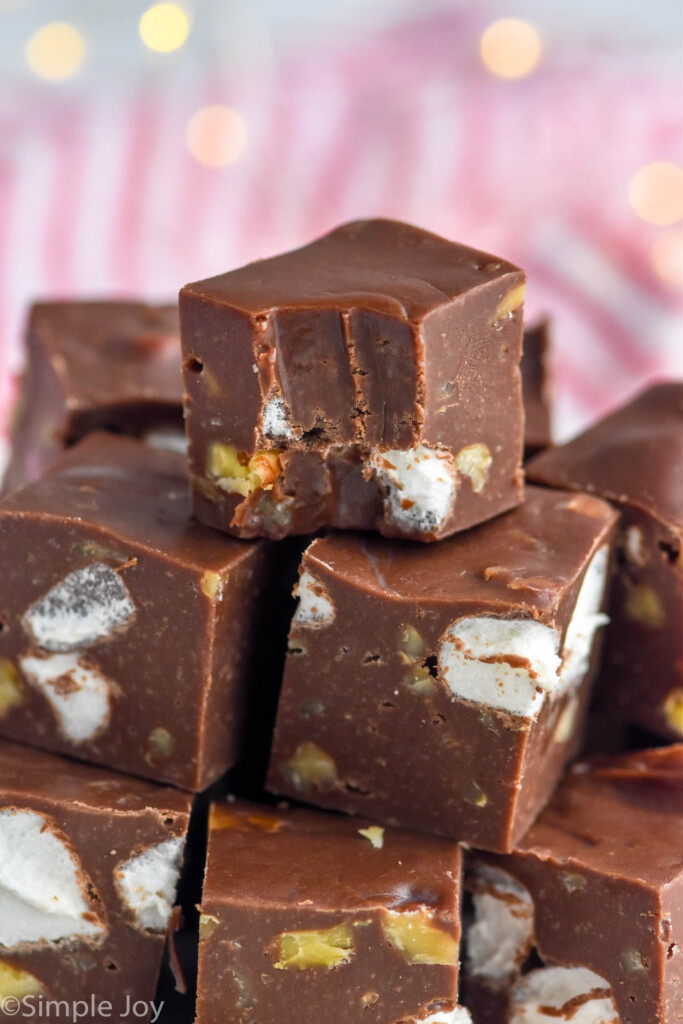 Close up photo of a stack of Rocky Road Fudge with a bite taken out of the top piece.