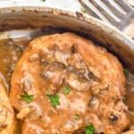 Pinterest graphic for Smothered Pork Chops. Text says "amazing Smothered Pork Chops simplejoy.com" Image shows Smothered Pork Chops in a pan