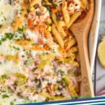 Pinterest graphic for Vegetarian Pasta Bake. Image shows a casserole dish of Vegetarian Pasta Bake with a wooden spoon for serving. Text says "Vegetarian Pasta Bake simplejoy.com"