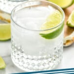 Pinterest graphic for Vodka Soda recipe. Image shows Vodka Soda with lime wedges. Text says, "Vodka Soda simplejoy.com"