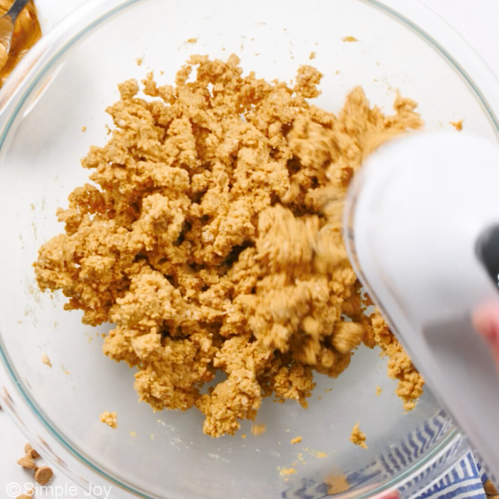 peanut butter ball dough being mixed together with a hand mixer