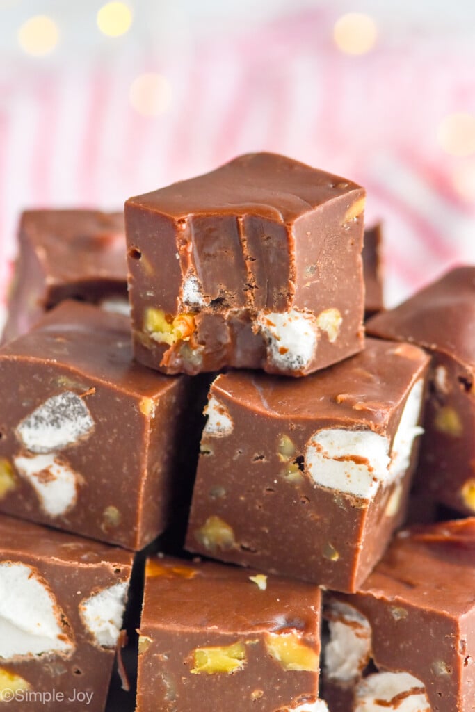 Close up photo of a stack of Rocky Road Fudge with a bite taken out of the top piece. - 9