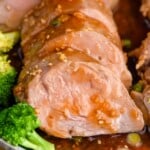 Photo of Teriyaki Pork Tenderloin sliced on a platter with broccoli.
