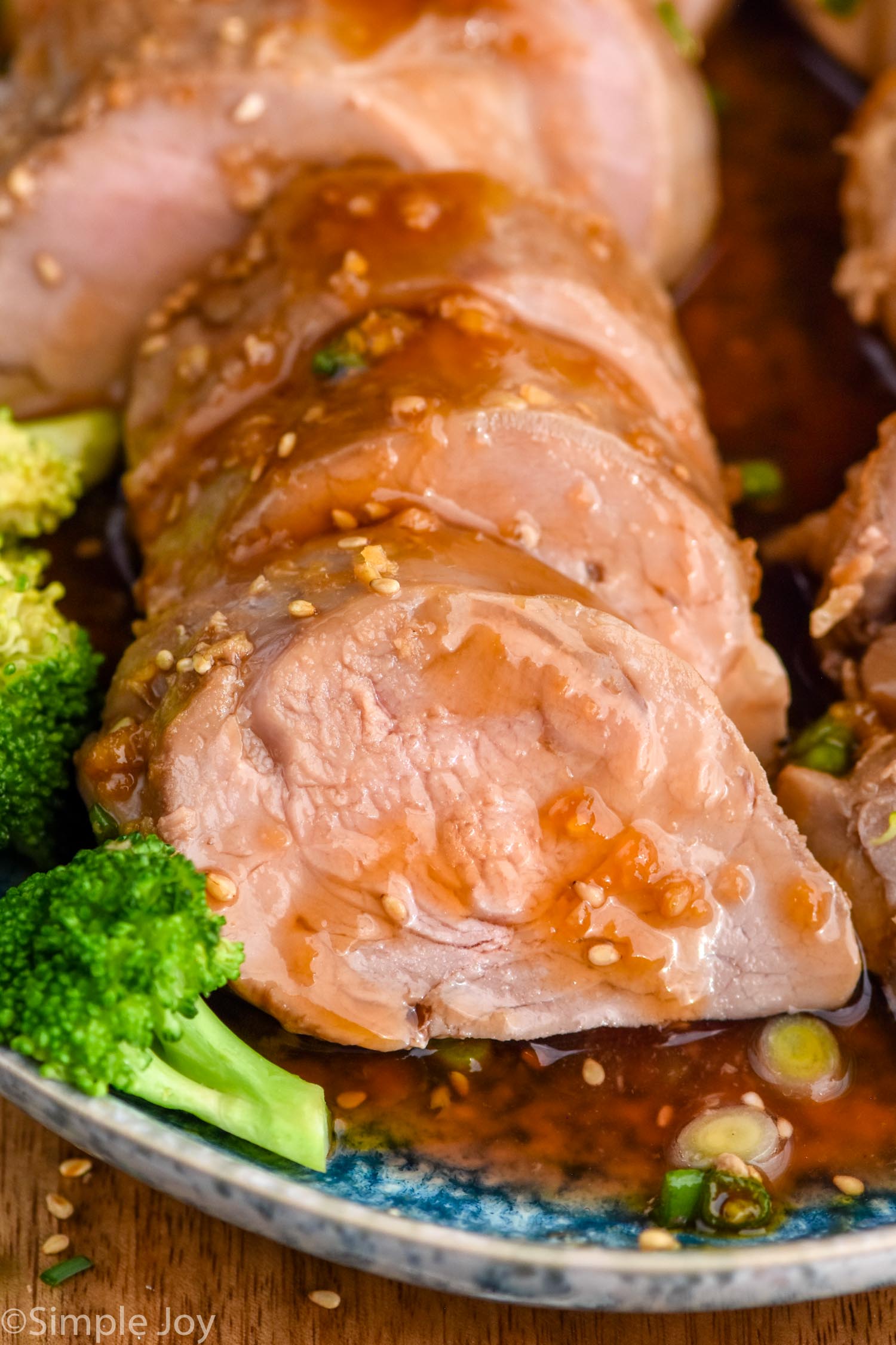 Photo of Teriyaki Pork Tenderloin sliced on a platter with broccoli.