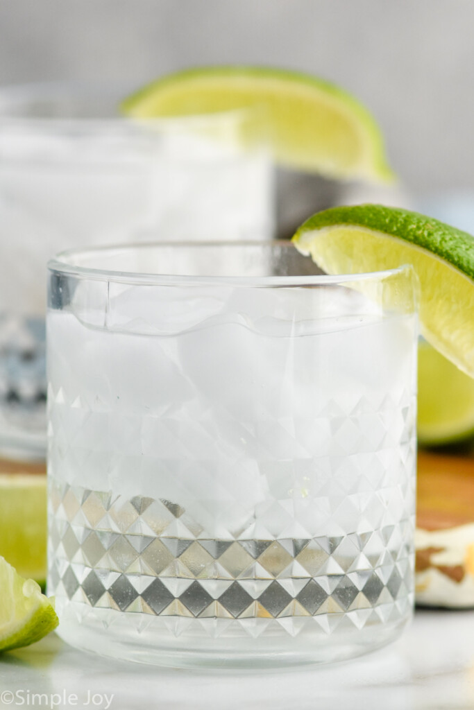 Side view of Vodka Soda with lime wedges