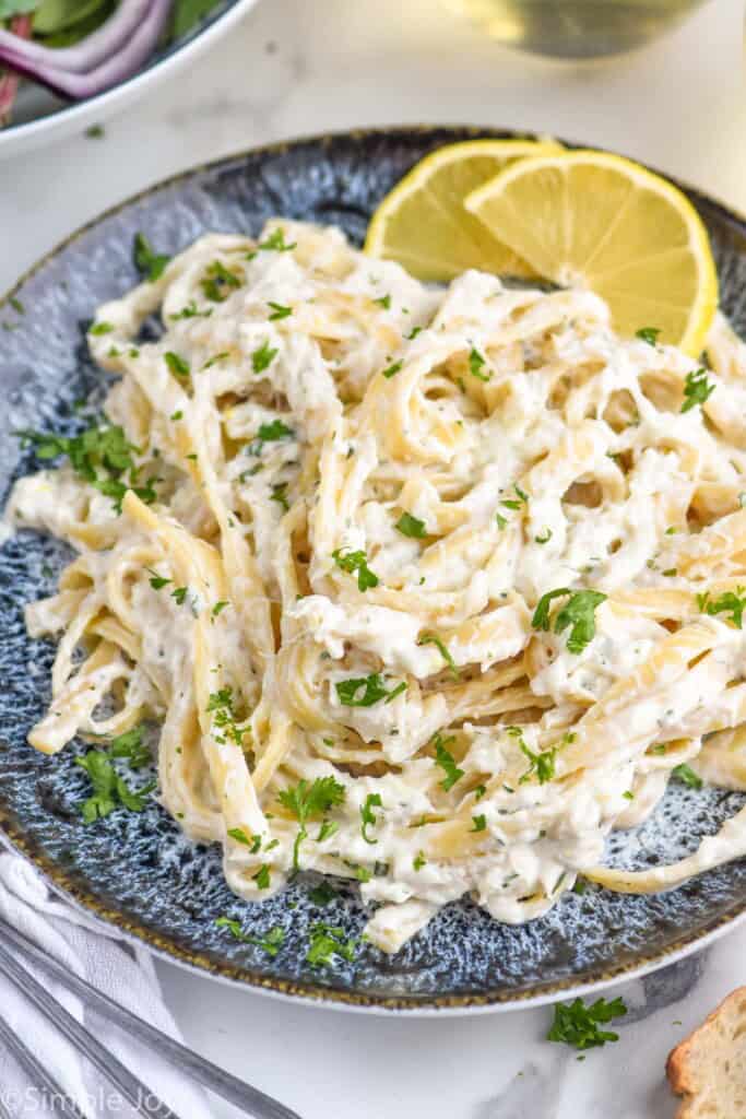 Bowl of Creamy Crab Pasta served with lemon slices