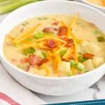 pinterest graphic of bowl of creamy potato soup with bacon topped with cheese, bacon, and scallions, says: "creamy bacon potato soup simplejoy.com"