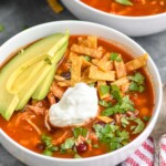 Bowl of Chicken Tortilla Soup garnished with avocado and sour cream