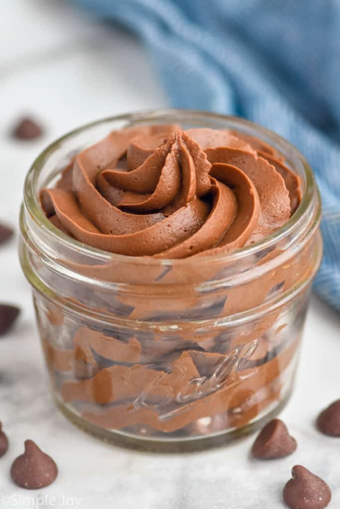 Jar of Chocolate Cream Cheese Frosting with chocolate chips beside