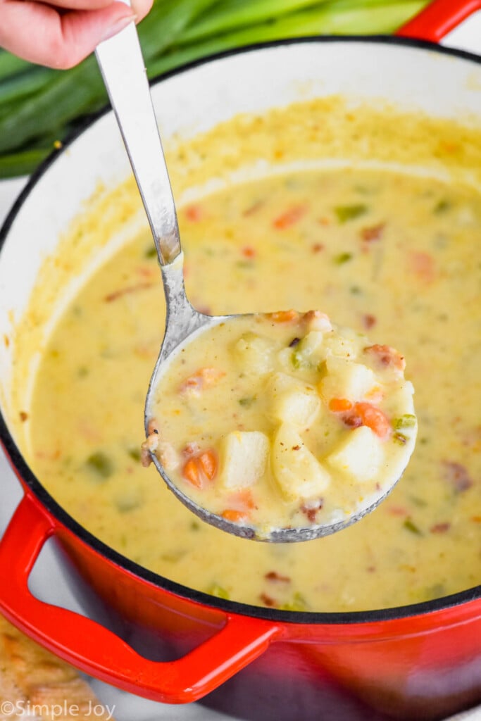 easy creamy potato soup being ladled out of a stock pot