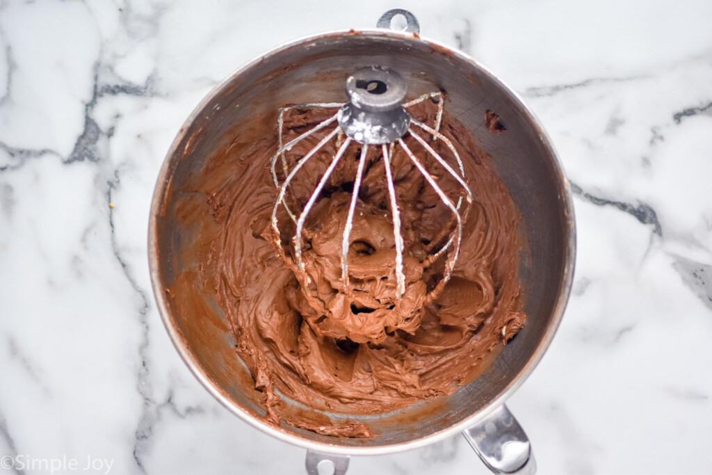 Overhead photo of bowl of Chocolate Cream Cheese Frosting with beater still in it