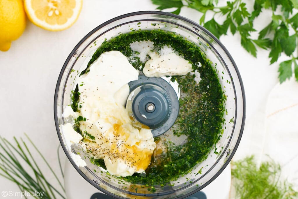 sour cream, mayonnaise, and honey added to greens in a food processor