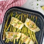 Pinterest graphic for Air Fryer Cod recipe. Text says, "the best Air Fryer Cod simplejoy.com." Image shows Air Fryer Cod and asparagus in air fryer basket.