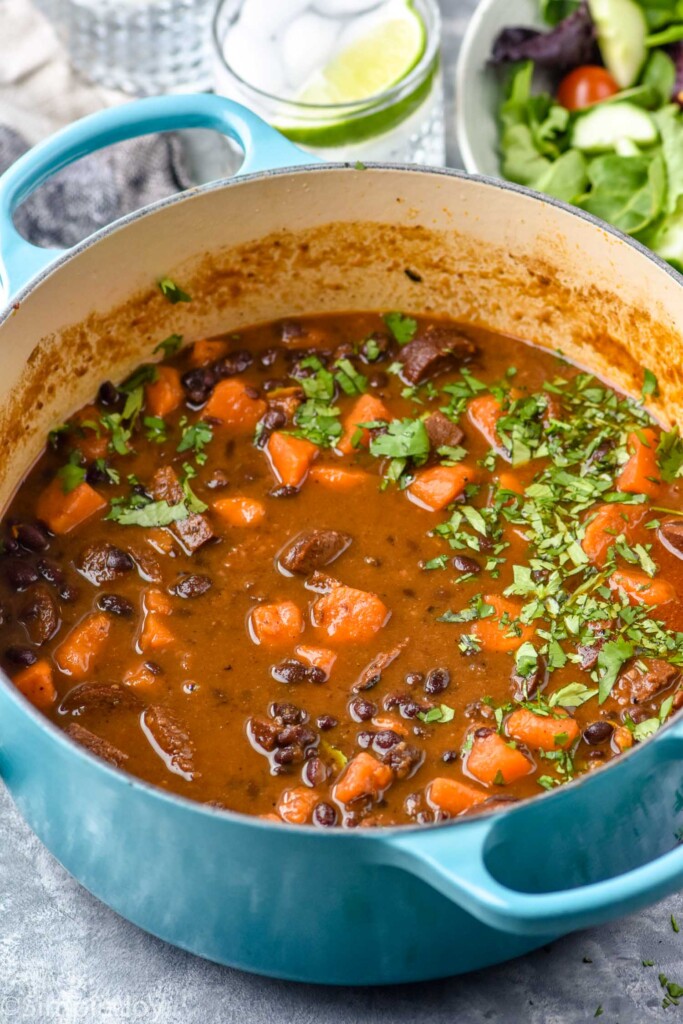 Pot of Black Bean Soup with Andouille with salad beside