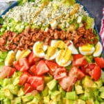 Pinterest graphic for Cobb Salad recipe. Text says, "the best Cobb Salad simplejoy.com." Image shows Cobb Salad