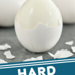 Pinterest graphic for Hard boiled eggs recipe. Image shows a hard boiled egg with shell partially peeled off. Text says, "Hard boiled eggs simplejoy.com"