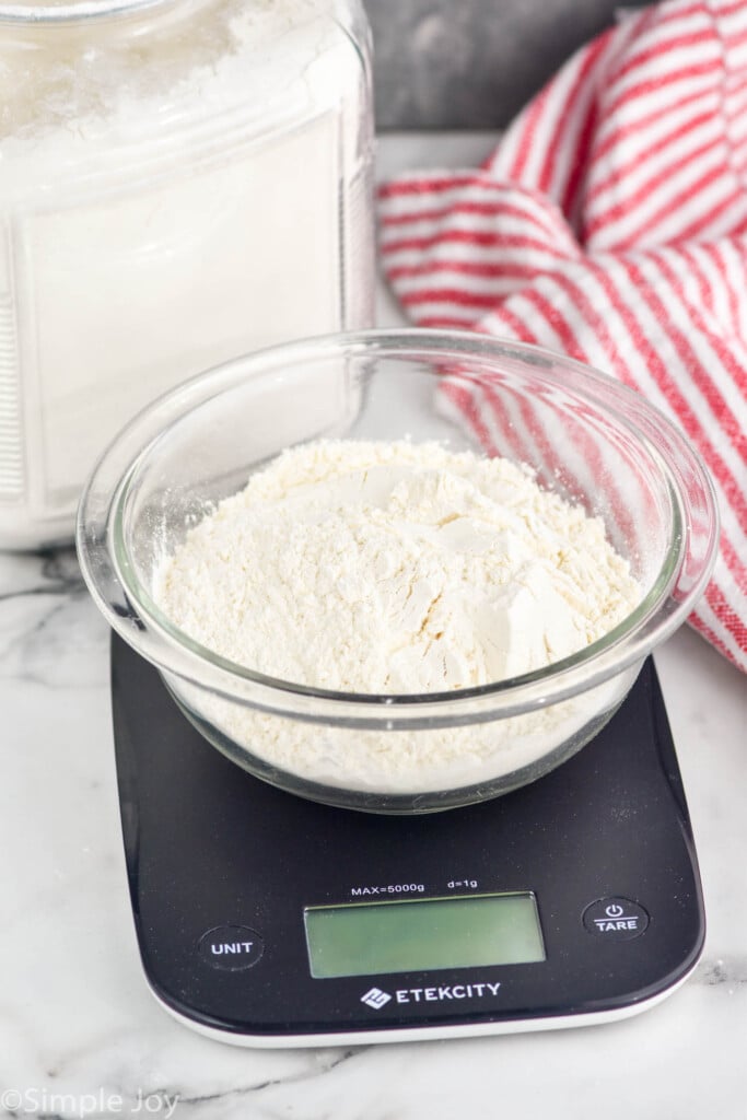 Bowl of flour on kitchen scale for How to Measure Flour