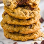 Pinterest graphic for Oatmeal Chocolate Chip Cookies recipe. Image shows a stack of Oatmeal Chocolate Chip Cookies with a bite taken out of the top cookie. Text says, "Oatmeal Chocolate Chip Cookies simplejoy.com"