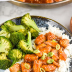 Pinterest graphic for Sesame Chicken recipe. Text says, "the best Sesame Chicken simplejoy.com." Image shows Sesame Chicken with broccoli and rice.