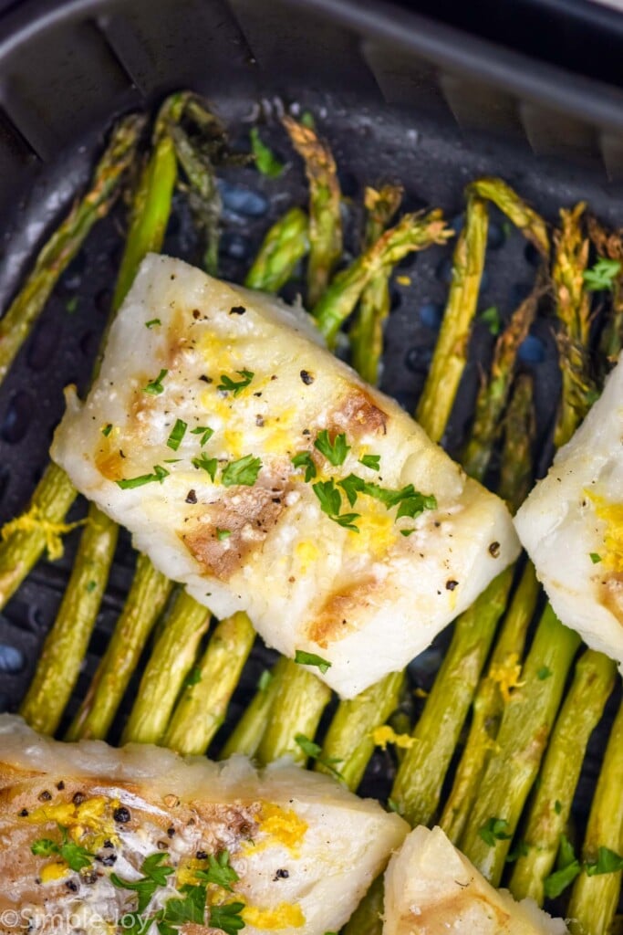 Cod and asparagus in air fryer basket for Air Fryer Cod recipe