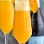 Side view of Bellinis garnished with peach slices