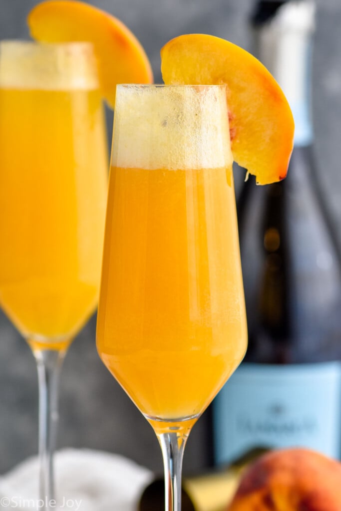 Side view of Bellinis garnished with peach slices