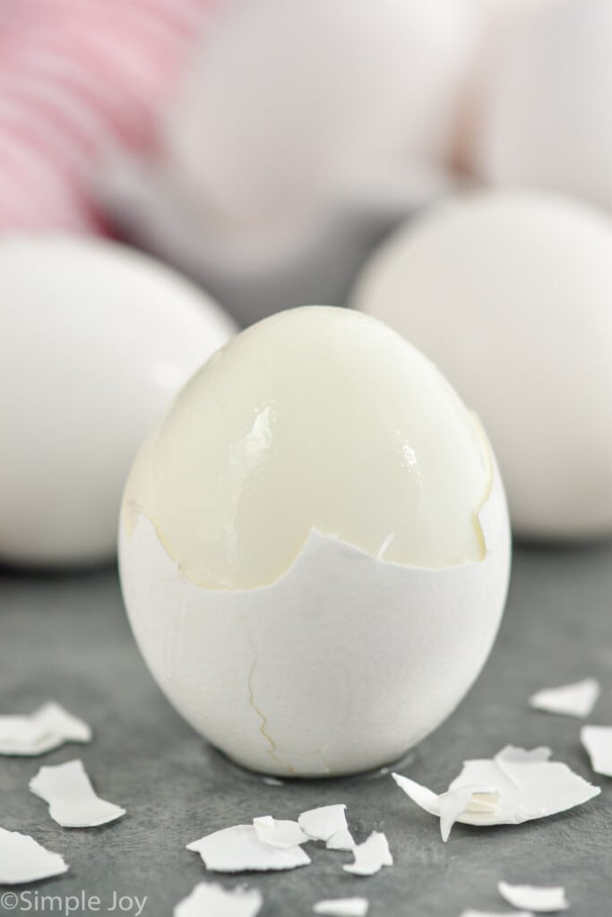 Side view of Hard boiled egg with shell partially peeled off