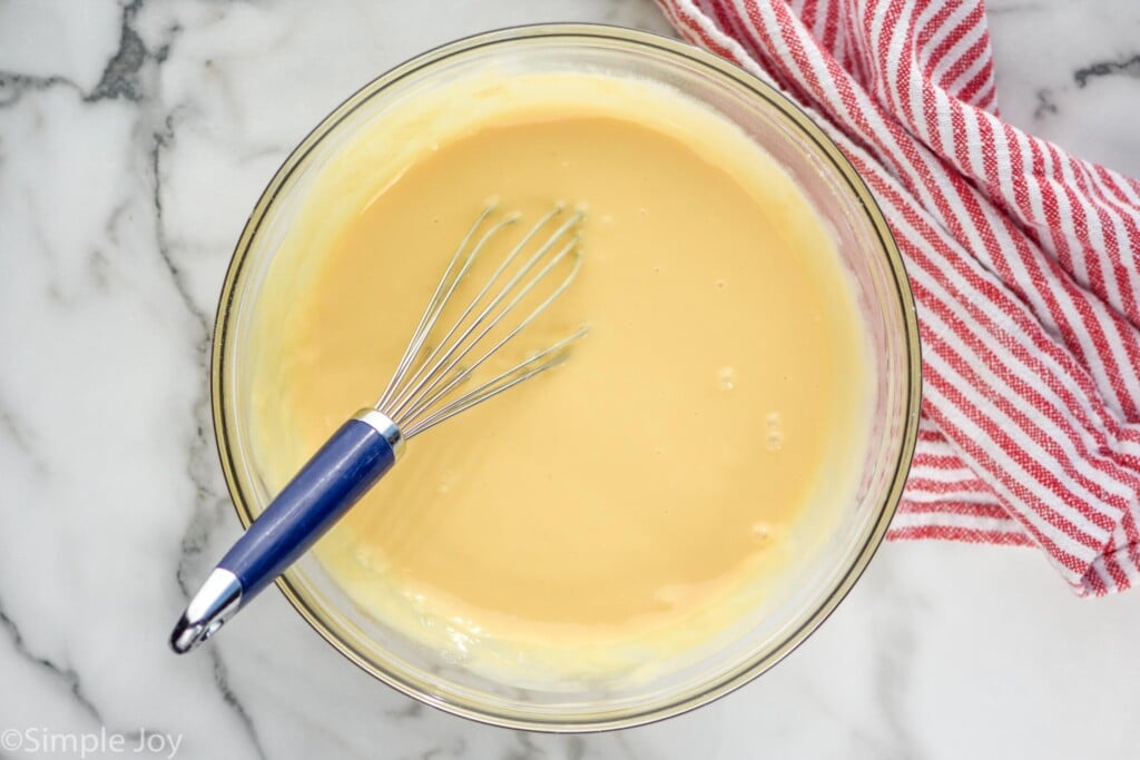 Overhead view mixing bowl of ingredients with whisk for Banana Pudding recipe