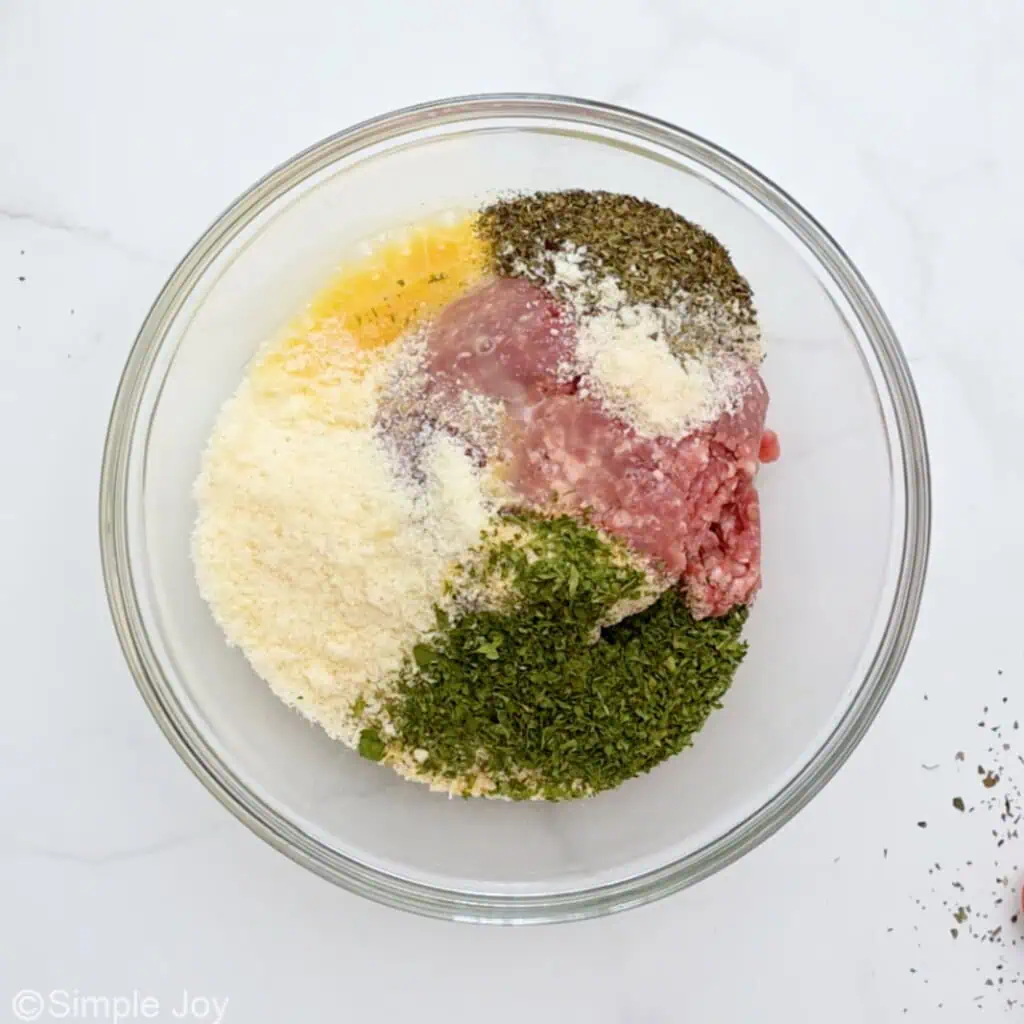 ingredients to make meatballs in a bowl - 4