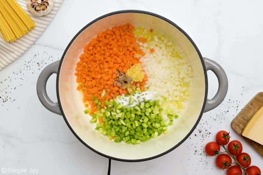 overhead of dutch oven with chopped vegetables to make soup