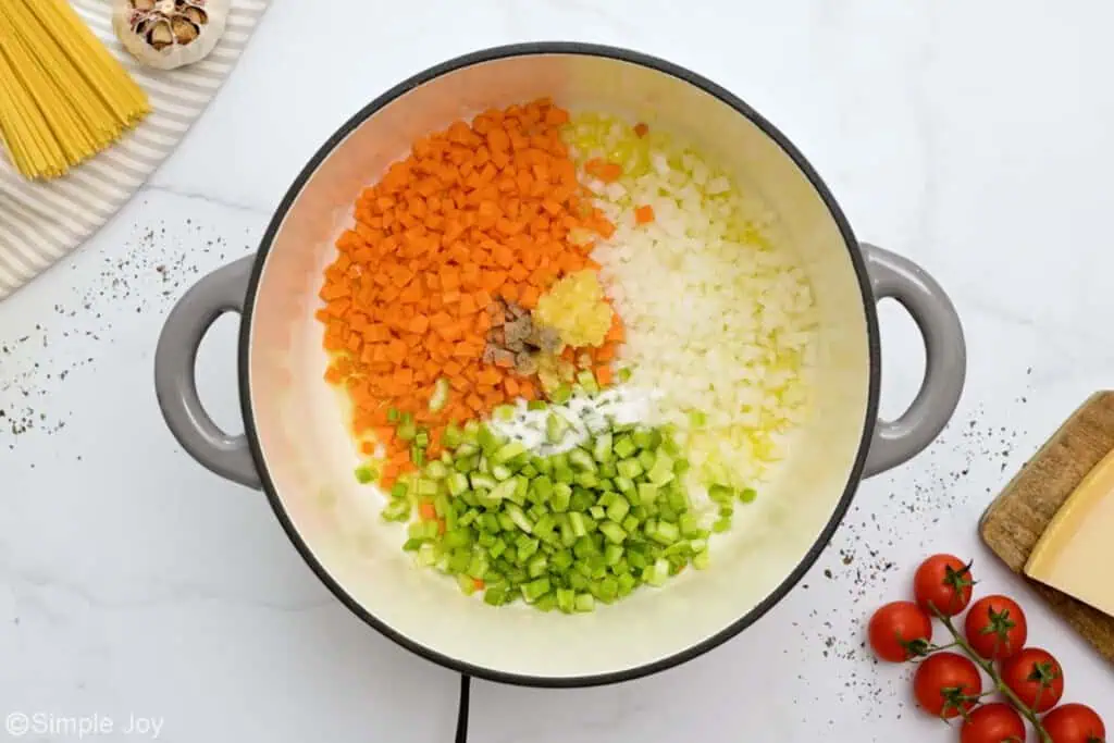 overhead of dutch oven with chopped vegetables to make soup - 5