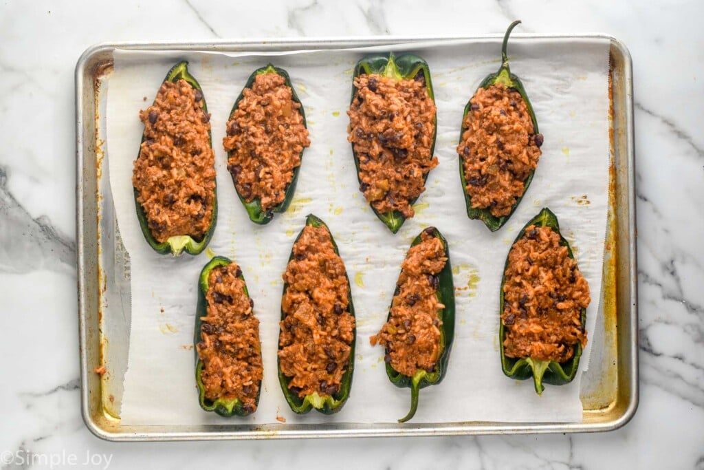 Overhead view of baking sheet with Stuffed Poblano Peppers recipe before baking