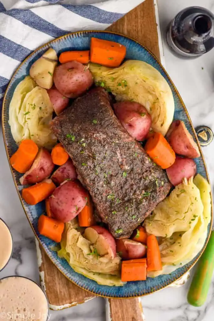 Overhead photo of Instant Pot Corned Beef on a platter with cabbage, potatoes, and carrots - 6