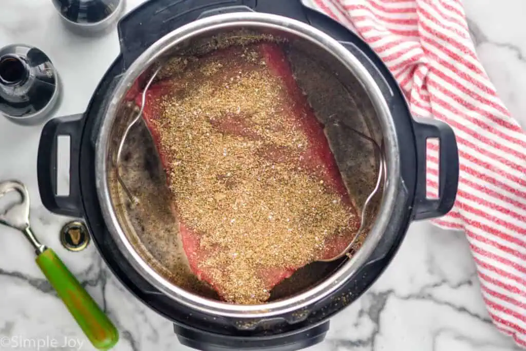 Overhead view of seasoned corned beef in an instant pot for Instant Pot Corned Beef recipe. - 4