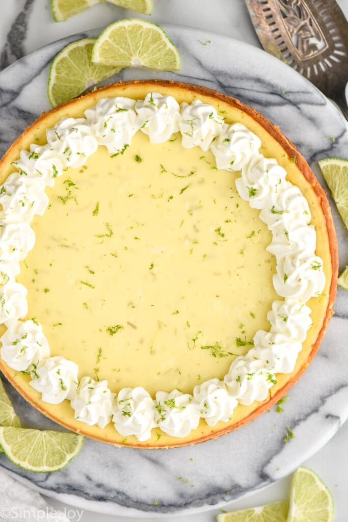 overhead of key lime cheesecake with lime slices surrounding