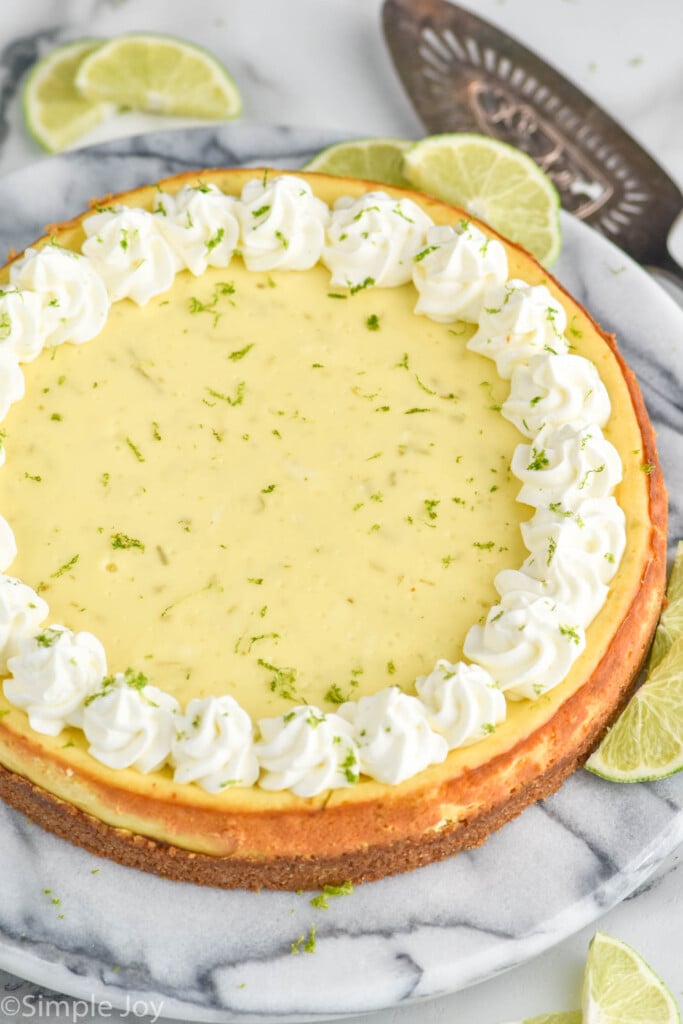 key lime cheesecake with lime slices surrounding.