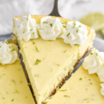 serving spatula lifting a slice of key lime pie cheesecake out of the cheesecake. - 10