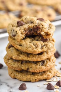 Stack of Oatmeal Chocolate Chip Cookies with a bite taken out of the top cookie.