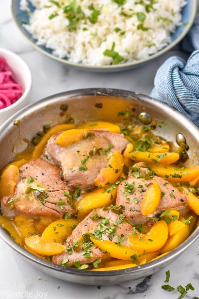 Skillet of Peach Jalapeño Tuna Steak recipe with bowl of rice beside