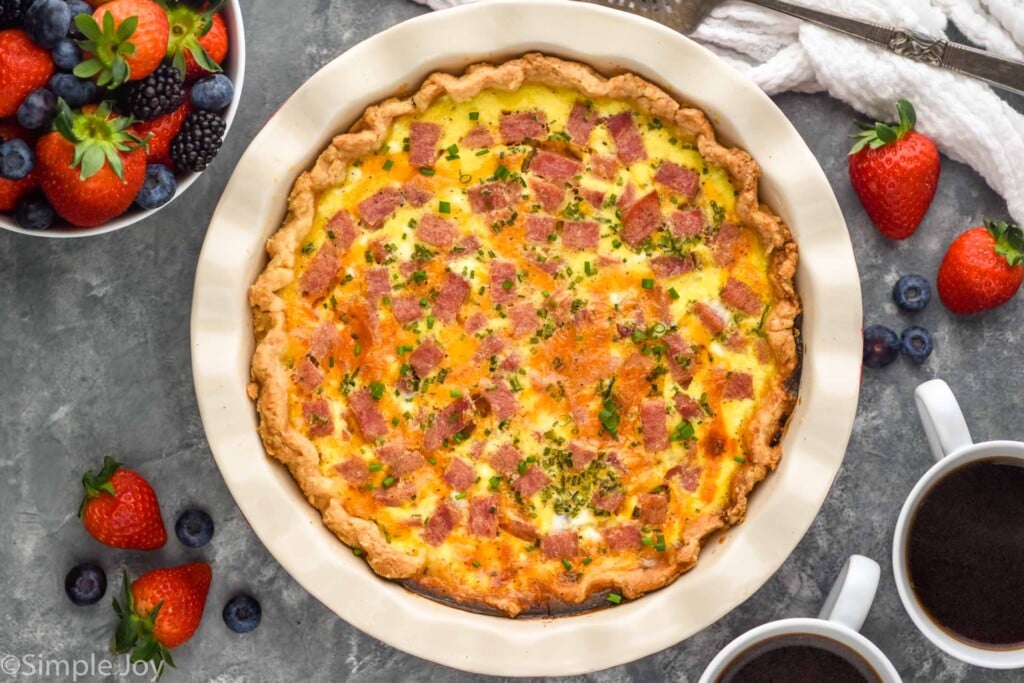 Overhead photo of Ham and Cheese Quiche with fruit and coffee beside