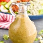 Bottle of Red Wine Vinaigrette with cobb salad behind