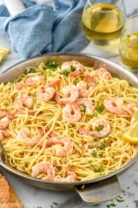 Skillet of Shrimp Linguine with glasses of wine beside