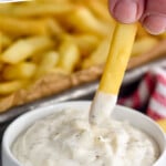 Pinterest graphic for Garlic Aioli recipe. Text says, "the best Garlic Aioli simplejoy.com." Image shows french fry being dipped into Garlic Aioli