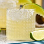 Pinterest graphic for Margarita recipe. Image shows Margarita with lime wedges. Text says, "the best Margarita simplejoy.com"