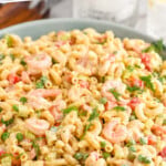 Pinterest graphic for Shrimp Pasta Salad recipe. Text says, "the best Shrimp Pasta Salad simplejoy.com." Image is a bowl of Shrimp Pasta Salad.