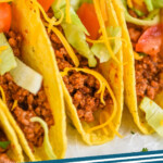 Pinterest graphic for Taco Meat recipe. Image shows tacos filled with Taco Meat recipe. Text says, "Taco Meat simplejoy.com"